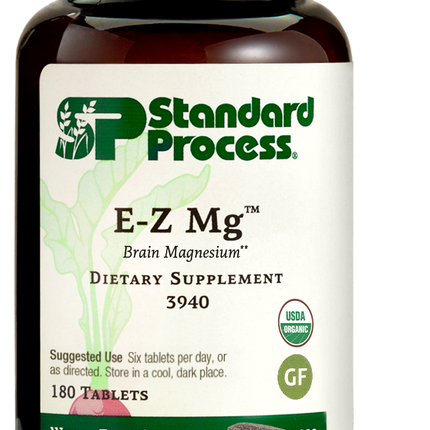 Image of E-Z Mg bottle next to tablets of magnesium supplements.