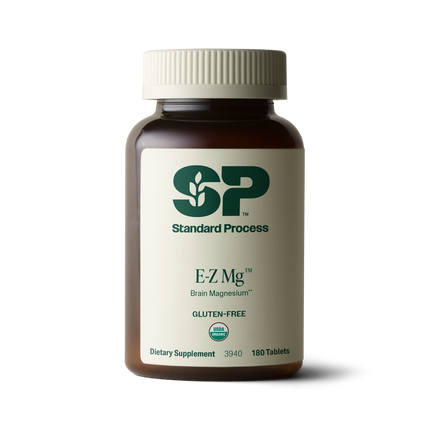 Image of E-Z Mg bottle next to tablets of magnesium supplements.