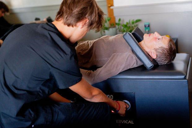 A patient undergoing traction treatment at Snow Holistic Health