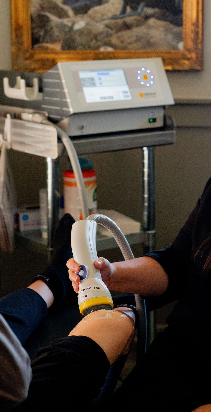 A patient having SoftWave therapy on his knee.
