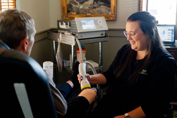 A patient having SoftWave therapy on his knee.