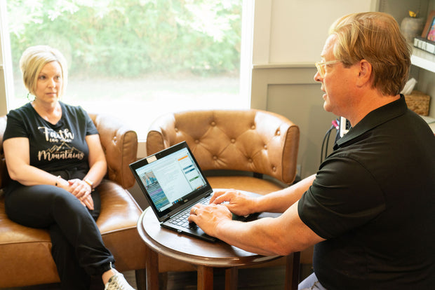 Dr. Eric Snow, DC meets with a patient to go over her functional medicine testing results.