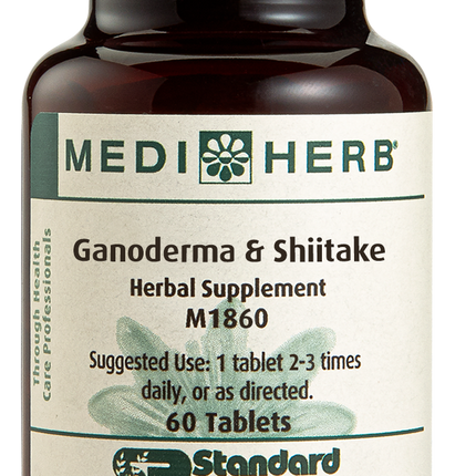 A bottle of Ganoderma & Shiitake herbal supplement next to a tablet.