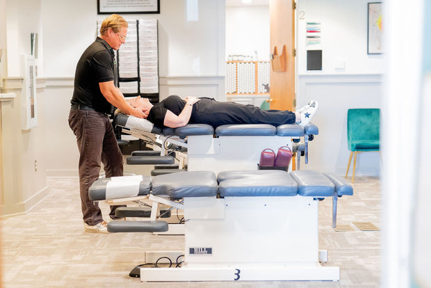 Dr. Eric Snow, DC, adjusts a patient during their chiropractic treatment as part of their holistic health plan.